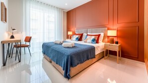 A modern hotel room with a large bed, a desk, and a chair. - Adega Luxury Near Lagos City Center With Pool (Lagos)