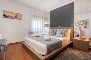 A modern bedroom with a large bed, a bedside table, and a nightstand. - Sea La Vie On the Beach City Center Marina (Lagos)