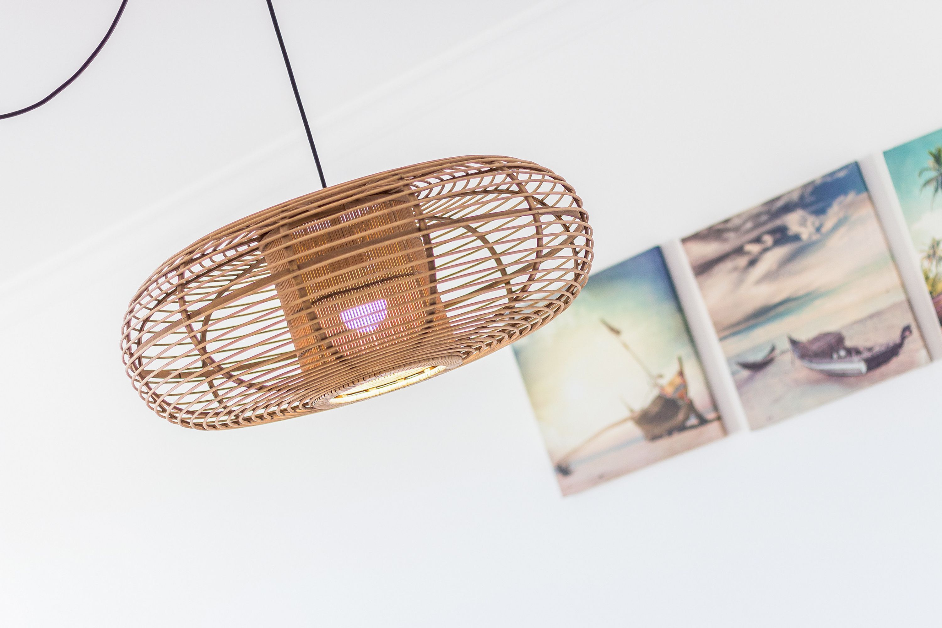 A woven pendant light fixture with a visible power cord.