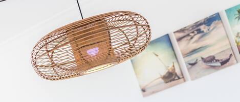A woven pendant light fixture with a visible power cord.