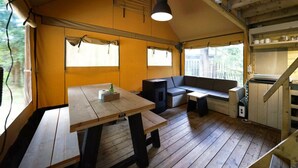 A cozy interior with a wooden table, bench seating, a hanging light fixture, and a staircase leading to an upper level. - Holiday Home in Otterlo With Terrace (Otterlo)