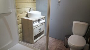 A bathroom with a white sink, wooden vanity, and a toilet. - Holiday Home in Otterlo With Terrace (Otterlo)