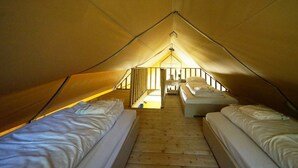 A tented accommodation with two beds, a wooden floor, and a central staircase. - Holiday Home in Otterlo With Terrace (Otterlo)