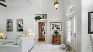 A modern living room with a sofa, a lamp, and wall art. - Private Pool, Wifi, Outdoor Lounger, Family Fun (Rotonda West)