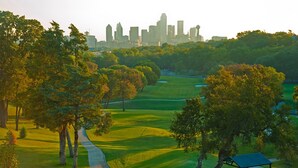 A golf course with a city skyline in the background. - Dallas Luxury Smart Home Near Golf, Trails, Tennis, Shopping & Downtown Access (Dallas)