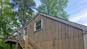 A wooden shed with a wooden staircase leading to a window. - Backwoods Studio: 11.6ac Forest (Noblesville)
