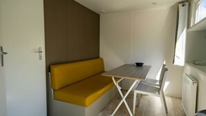 A compact room with a sofa, a table, and a chair. - Holiday Home in Amstelveen With Terrace (Amstelveen)