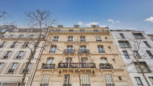 A multi-story building with a classic architectural style, featuring balconies with wrought iron railings and a symmetrical facade. - COMBINING COMFORT, TRANQUILITY & A PRIME LOCATION MONTMARTRE (Paris)