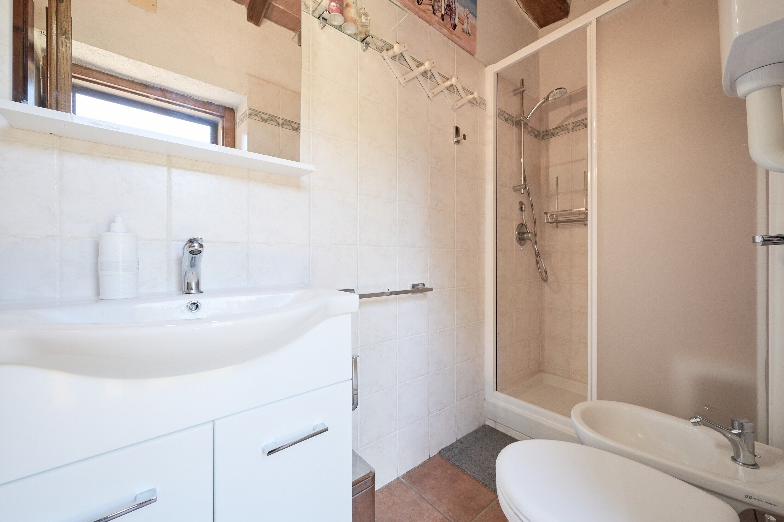Un bagno con un lavandino bianco, una vasca da bagno e un box doccia.