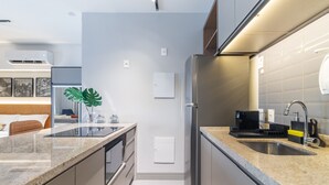 A modern kitchen with a granite countertop, stainless steel appliances, and a built-in oven. - Landing 508 in S o Paulo (São Paulo)