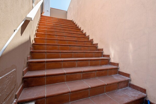 A staircase with terracotta steps leading upwards.