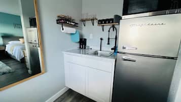 Coffee/tea maker, fridge, microwave, cookware/dishes/utensils