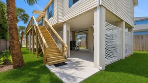 A two-story house with a wooden staircase, a covered porch, and a fenced backyard. - Steps to Beach Walk to Pier, Restaurants & Nightlife Near Downtown & Amphitheatre (St. Augustine)