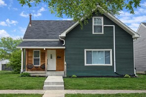 A two-story house with a front porch, a chimney, and a mailbox. - Grant’s Fresh Modern Charm 3B 2B (Noblesville)