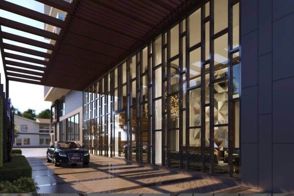 A modern building with large windows, a covered walkway, and a parked car. - Solaris Luxury Residence | Osu • Pool • Gym (Accra)