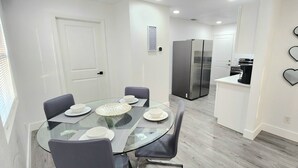 A modern kitchen with a refrigerator, oven, and coffee maker. - 2-bedroom house in fantastic Hudson with cool AC breeze (Hudson)