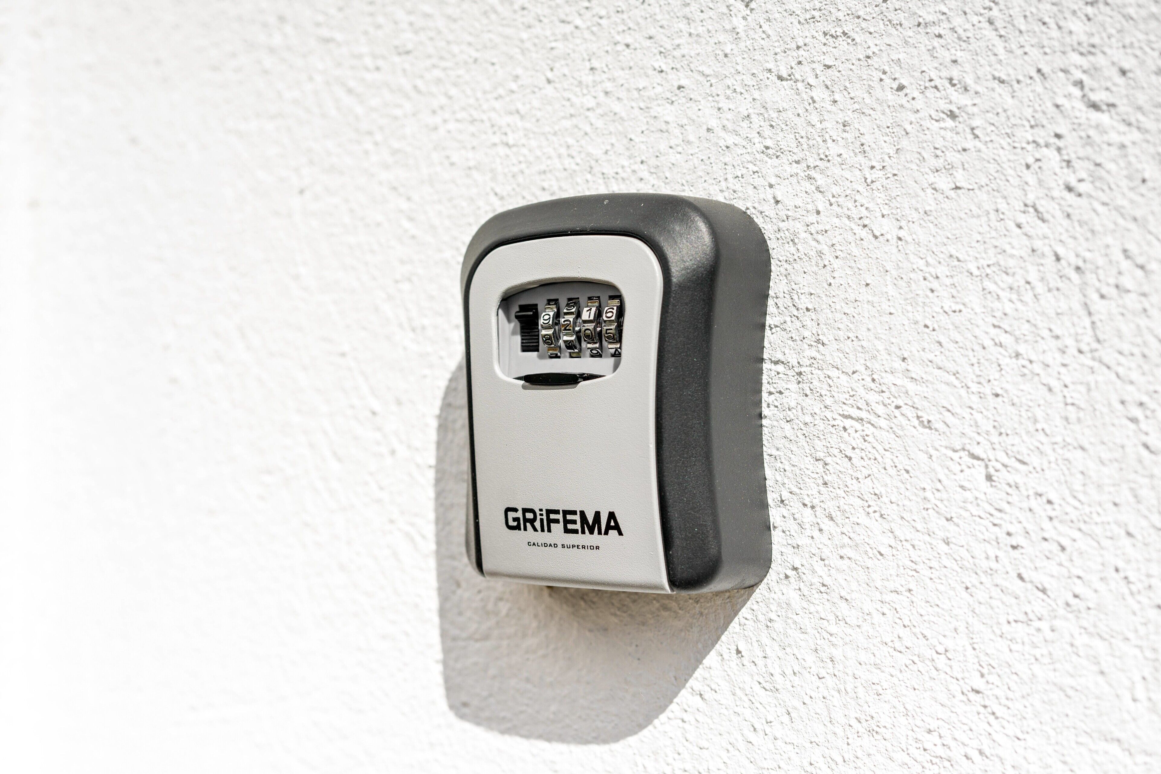 A wall-mounted GRIFEMA keypad lock.