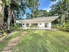 A modern house with a swimming pool, surrounded by lush greenery and trees. - Charming 3-bedroom house with AC in Playa Negra Playa Viejo (Playa Negra, Puerto Viejo de Talamanca)