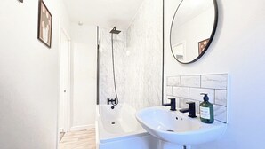 Shower, hair dryer, towels, shampoo