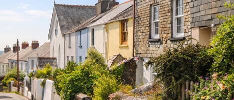 A row of traditional stone houses with a narrow street.
