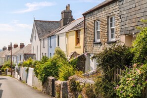 A row of traditional stone houses with a narrow street.