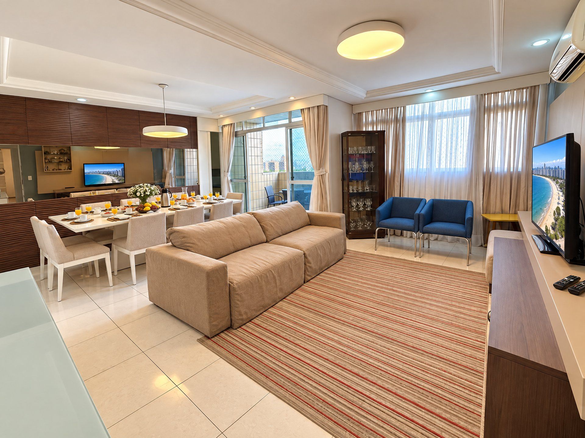 A modern living room with a sofa, dining area, and a television.