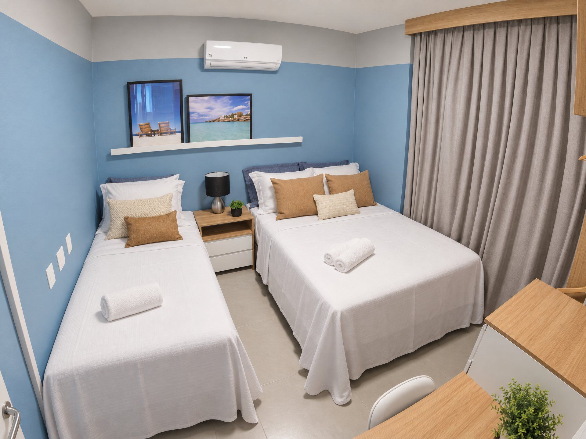 A hotel room with two beds, a desk, a chair, a nightstand, a lamp, a potted plant, and a window with curtains.