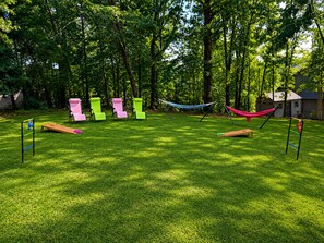 A grassy outdoor area with swings, a hammock, and a small wooden structure. - Ozark Calling -- Ride-In Ride-Out MTB Basecamp, Premium Location (Bella Vista)