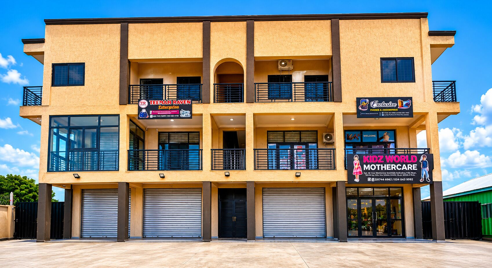 A multi-story building with commercial spaces on the ground floor, including a business with a sign for 'Kidz World Mothercare' and another for 'Exclusive.'