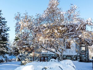 A snow-covered landscape with a stone building, a wooden fence, and a bench. - Chalet Remondet by Interhome (Sarre)