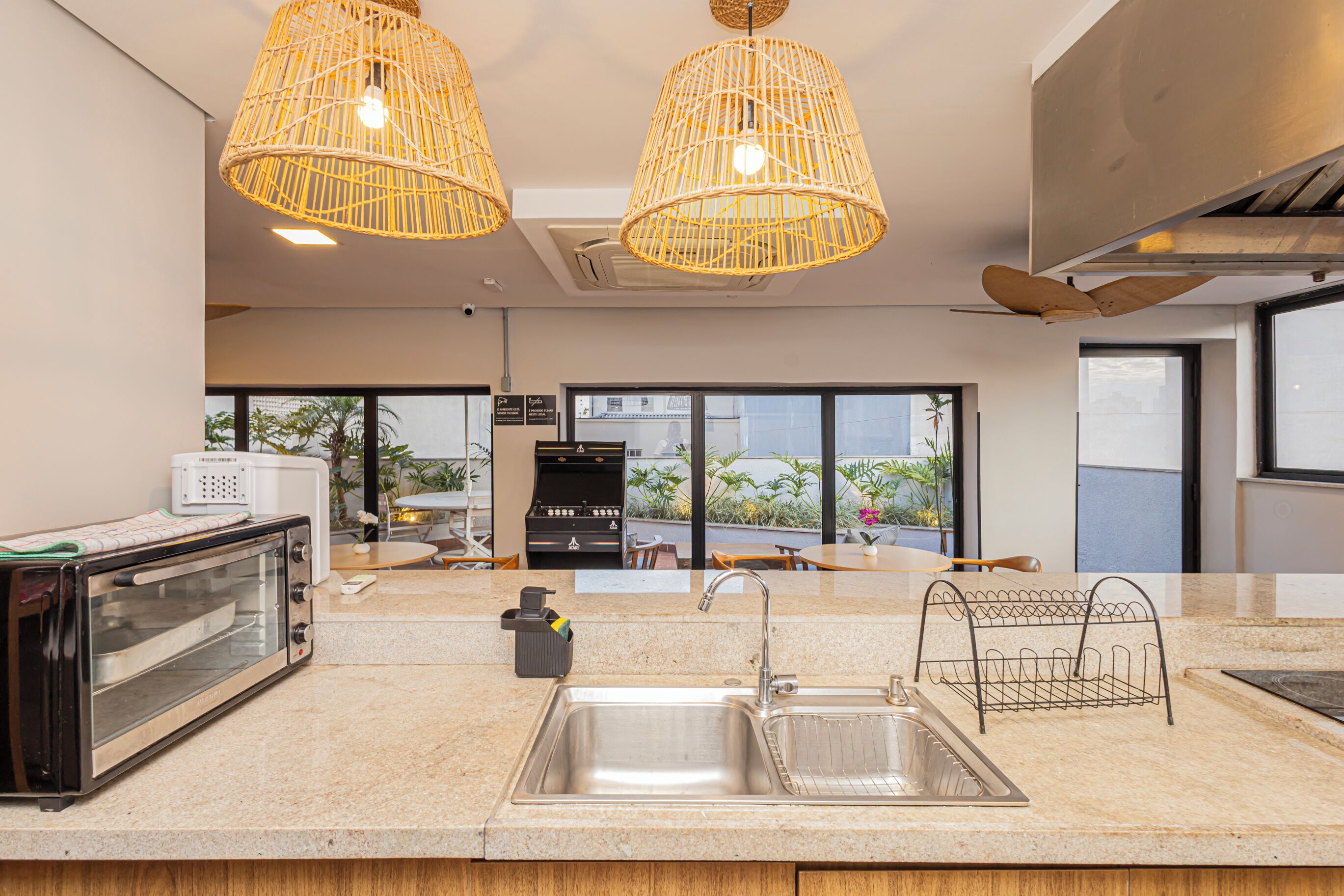 A modern kitchen with a built-in toaster, a sink, and a grill station.