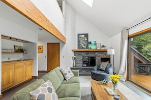 A modern living room with a sofa, coffee table, and a fireplace. - New Listing! Peaceful 3-bedroom condo in Stowe - access to the Rec Path and more (Stowe)