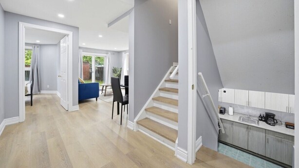 A modern interior with a staircase, a dining area, and a kitchen. - Private 1BR Apt | WiFi | Parking | Nr all Amenities (Mississauga)