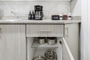 A kitchen with a coffee maker, hand soap, and jars labeled 'FILTERS' on the countertop. - Private 1BR Apt | WiFi | Parking | Nr all Amenities (Mississauga)