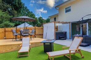 A backyard with a wooden deck, a grill, outdoor furniture, and a pergola with a white canopy. - Private Hot Tub Retreat | King Bed | Outdoor Oasis (Winston-Salem)