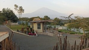 A wooden staircase leading to a building with a view of a mountain.