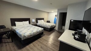 A hotel room with two beds, a desk, a TV, and a kitchenette. - Efficient Extended Stay Retreat Near Vancouver Waterfront Park - 0.7 mile (Clark County)
