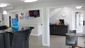 A modern kitchen with a coffee machine, a TV mounted on the wall, and a counter with a QR code. - 2 Accommodations 1.3 Mi from Reflection Riding Arboretum | Pets Allowed (Chattanooga)