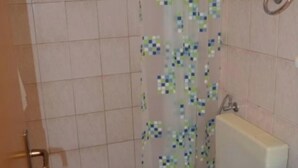 A bathroom with a toilet, a bathtub, and a sink.