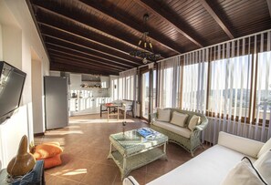 A modern living room with a sofa, coffee table, and a television. - Cozy Flat with a Lovely View in Bodrum near Beach (Bodrum)