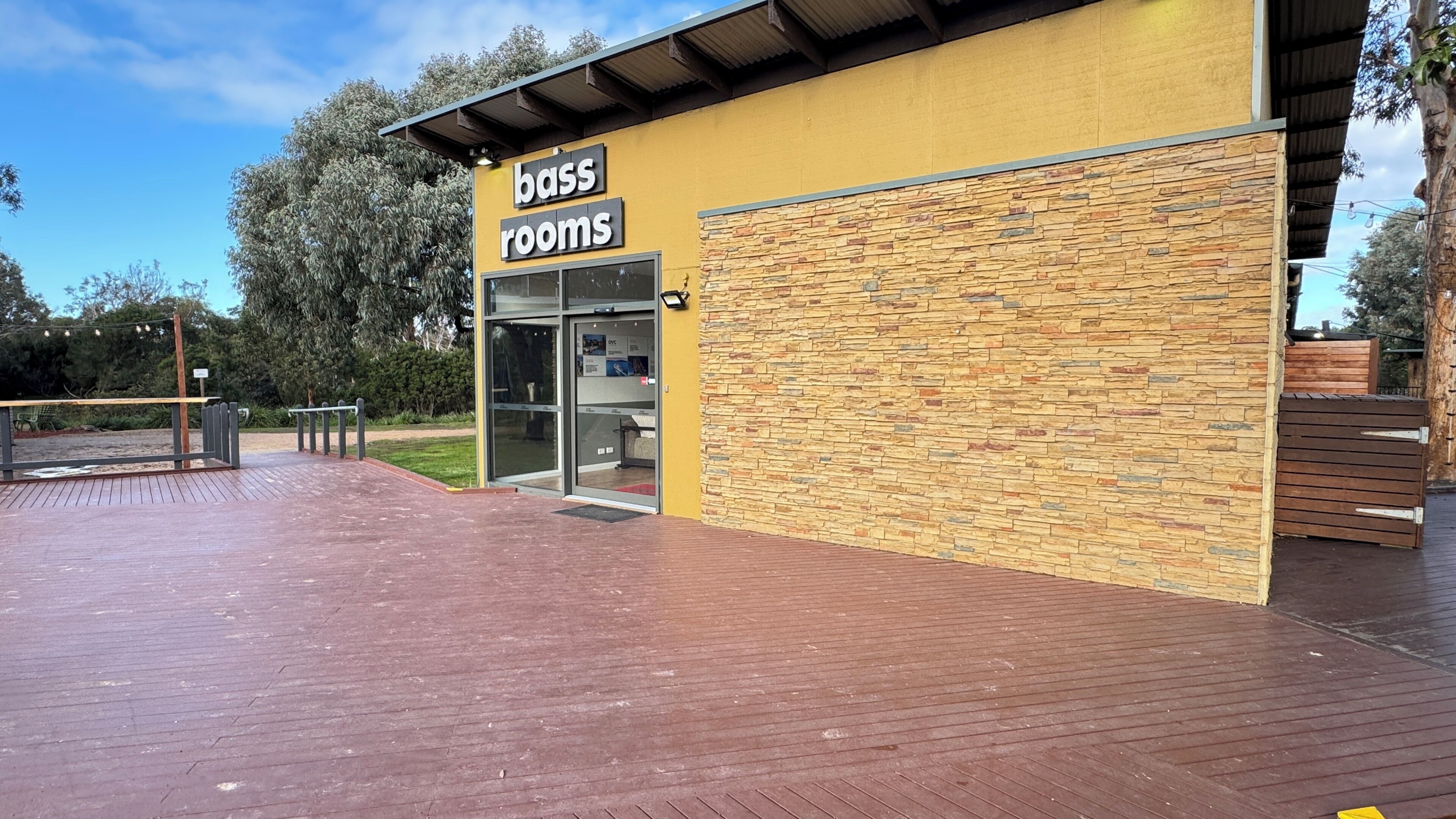 A building with a sign reading 'bass rooms' and a stone facade.