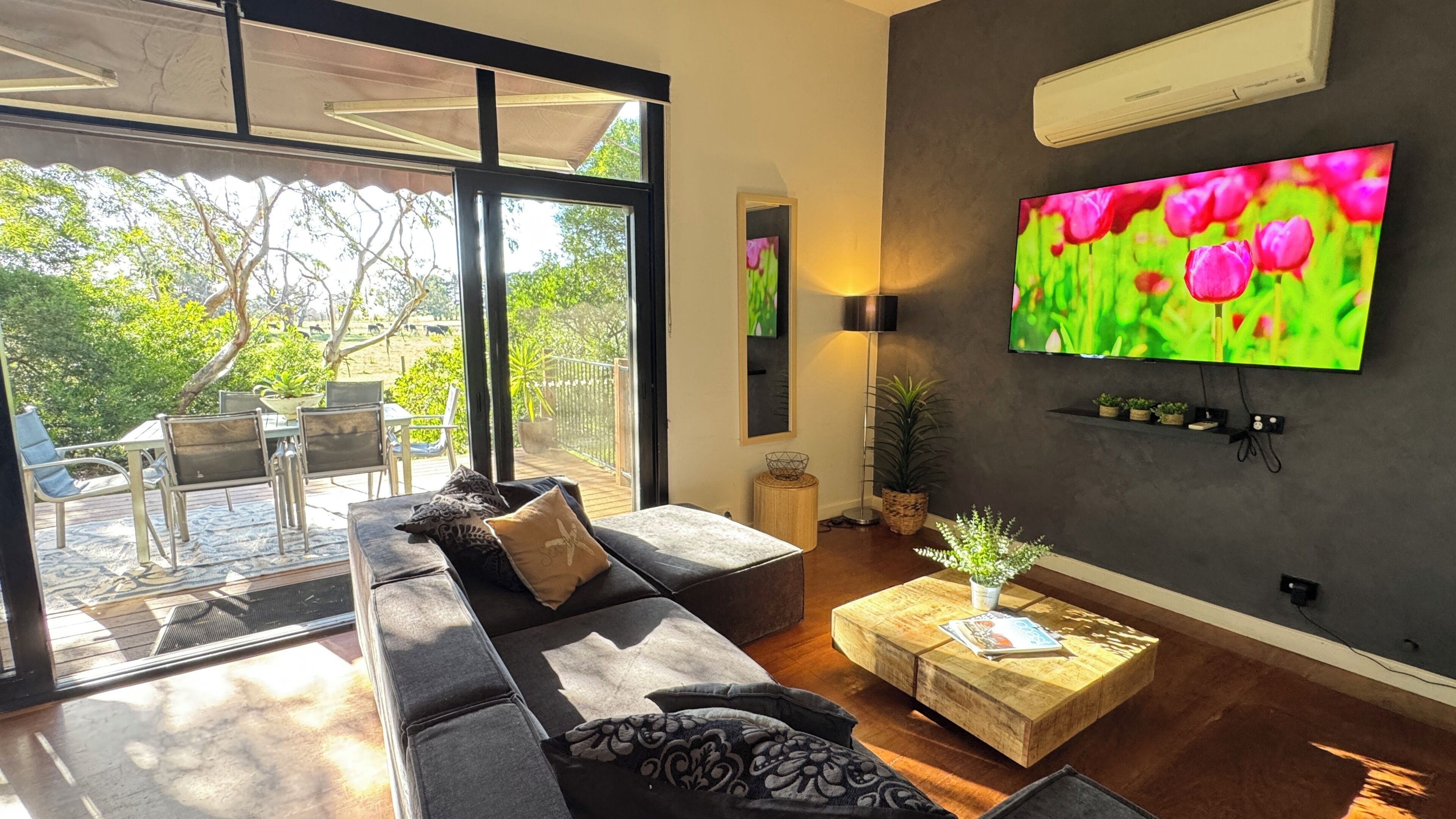 A modern living room with a sofa, coffee table, and TV.