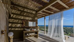 A bathroom with a large mirror, two sinks, and a vanity. - Romantic Private Pool Villa with Spectacular 180° Ocean Views (Korissia)