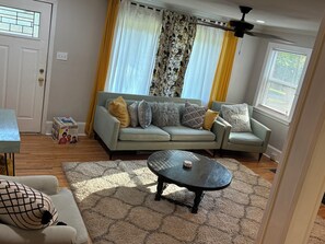 Living area - West side gem on a half-acre lot. Sunroom for indoor/outdoor living. Book today! (Charlotte)