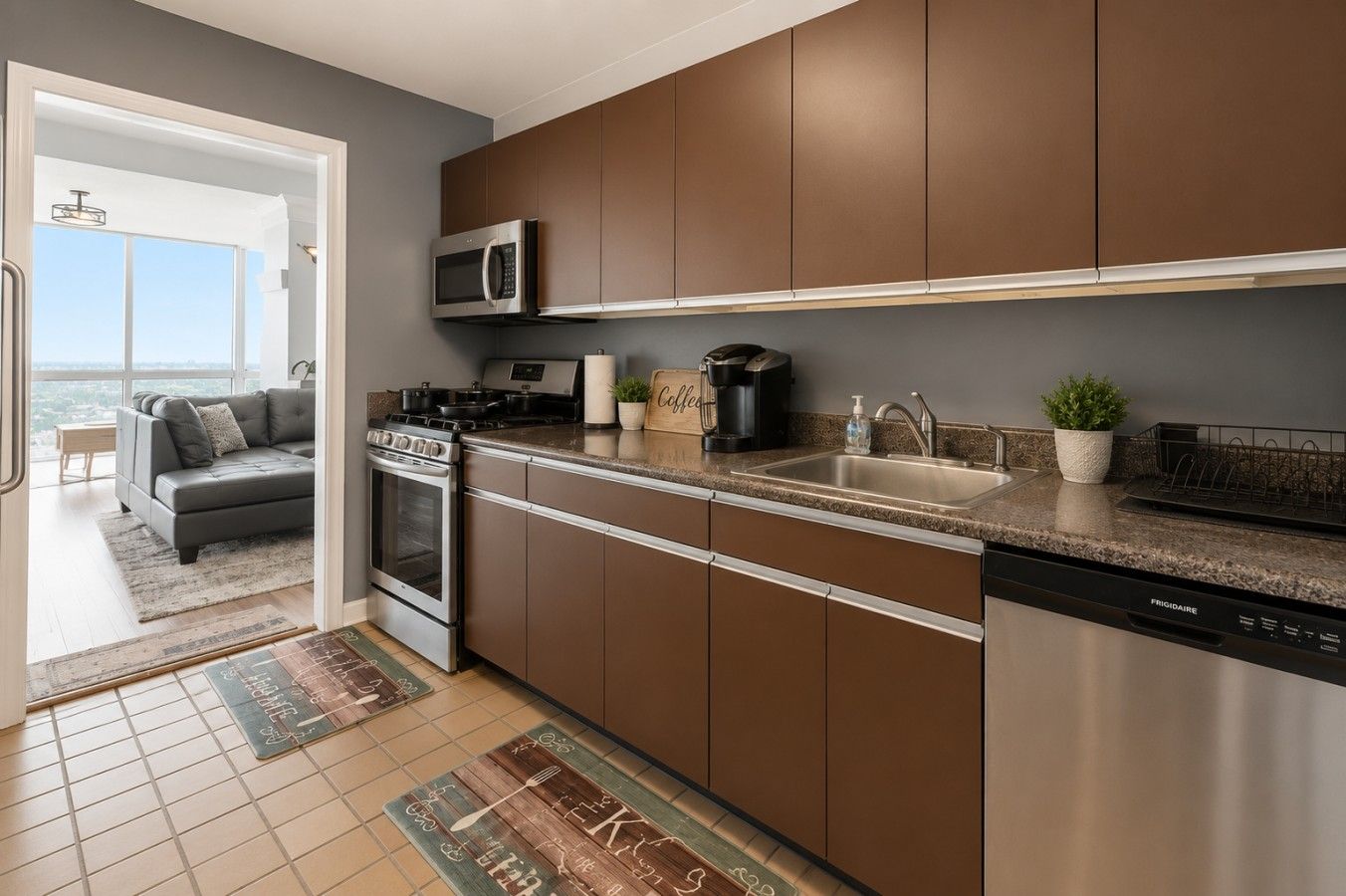 A modern kitchen with stainless steel appliances, a built-in microwave, and a dishwasher.