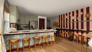 A kitchen with a central island, bar stools, and a striped wall with decorative plates. - Boutique 4BR Retreat w/Swim Spa • Sauna • Fire Pit (Georgetown)