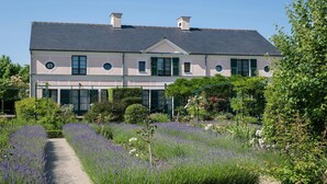 A two-story building with a garden in front.