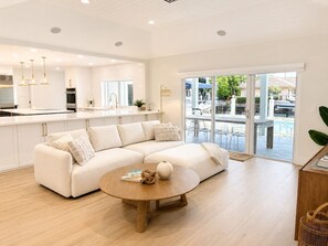 A modern kitchen with white cabinets, a built-in oven, and a large window. - Waterfront Home in Boca Raton ready to make memories (Boca Raton)