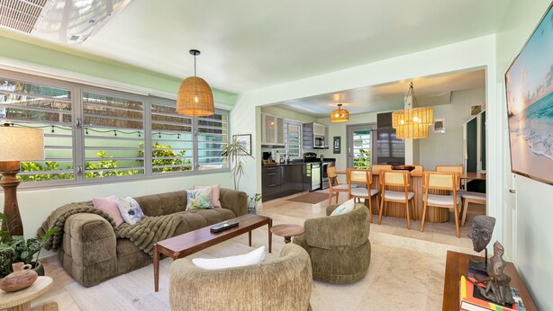 A spacious living area with a sofa, armchairs, a coffee table, and a dining area with chairs and a table. - 4BR Pool Home | 5 Min to Beach, San Juan (San Juan)