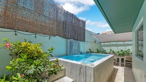 A swimming pool with steps leading up to it, surrounded by potted plants and a covered seating area. - 4BR Pool Home | 5 Min to Beach, San Juan (San Juan)